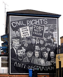 A picture of a black and white wall mural showing a group of people on a civil rights demonstration. The words "Civil Rights" is written at the top and "Anti Sectarian" at the bottom.