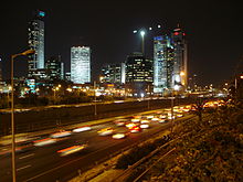 Night time picture of Ramat Gan showing many skyscrapers illuminating the city skyline